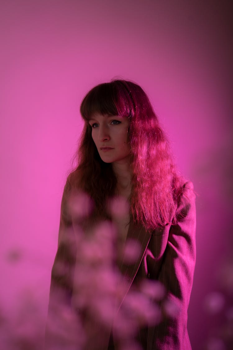 Woman In Brown Blazer Inside Pink Room