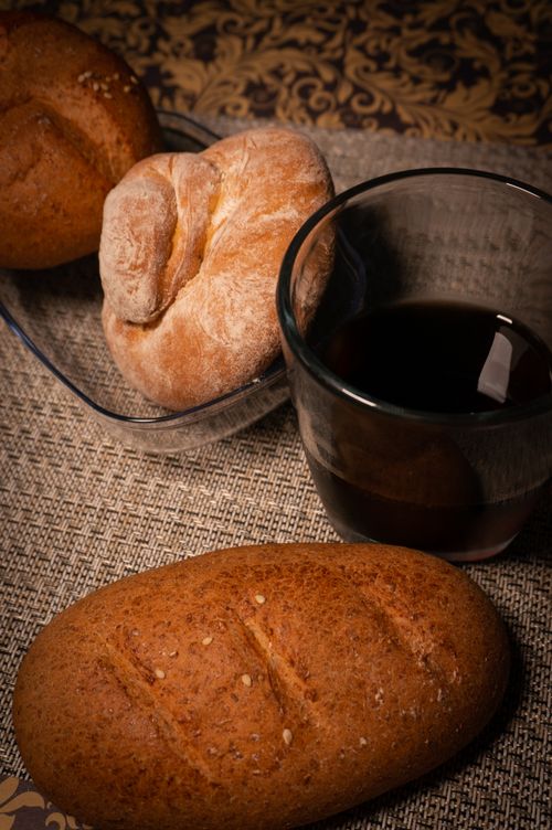 Free Warm selection of breads with a cup of coffee, depicting a cozy breakfast scene. Stock Photo