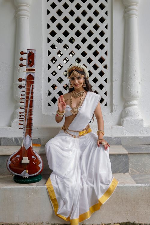 Free Indian model posing as a goddess with a sitar, embracing traditional Hindu culture. Stock Photo
