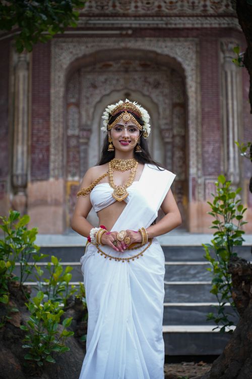 Free Stunning depiction of a woman as a traditional Indian goddess in an elaborate setting. Stock Photo