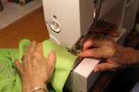 Person Sewing Green Cloth