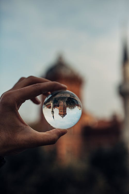 Person Holding Clear Lens Ball