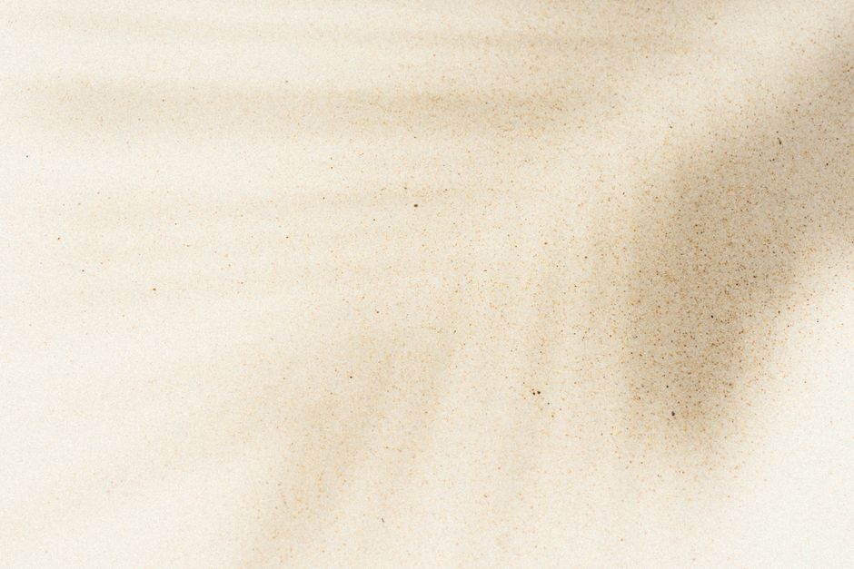 Artistic sand texture with natural shadows creating a serene abstract pattern, perfect for background use.