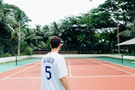 Man in White and Blue Jersey Shirt Standing on Tennis Court