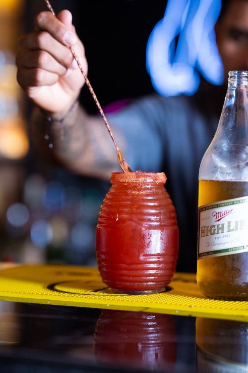 Free A vibrant michelada being prepared at a bar with beer and spices. Stock Photo