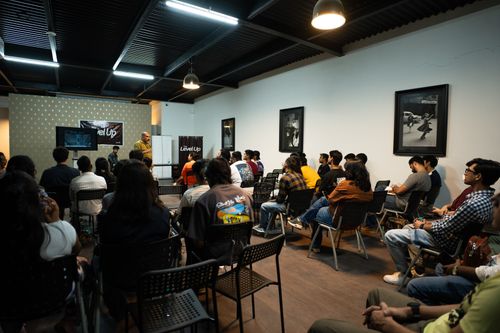 Free Participants attend a workshop presentation indoors with engaging visuals and discussions. Stock Photo