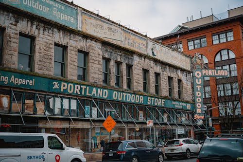 Cars Parked in Front of Brown Concrete Building