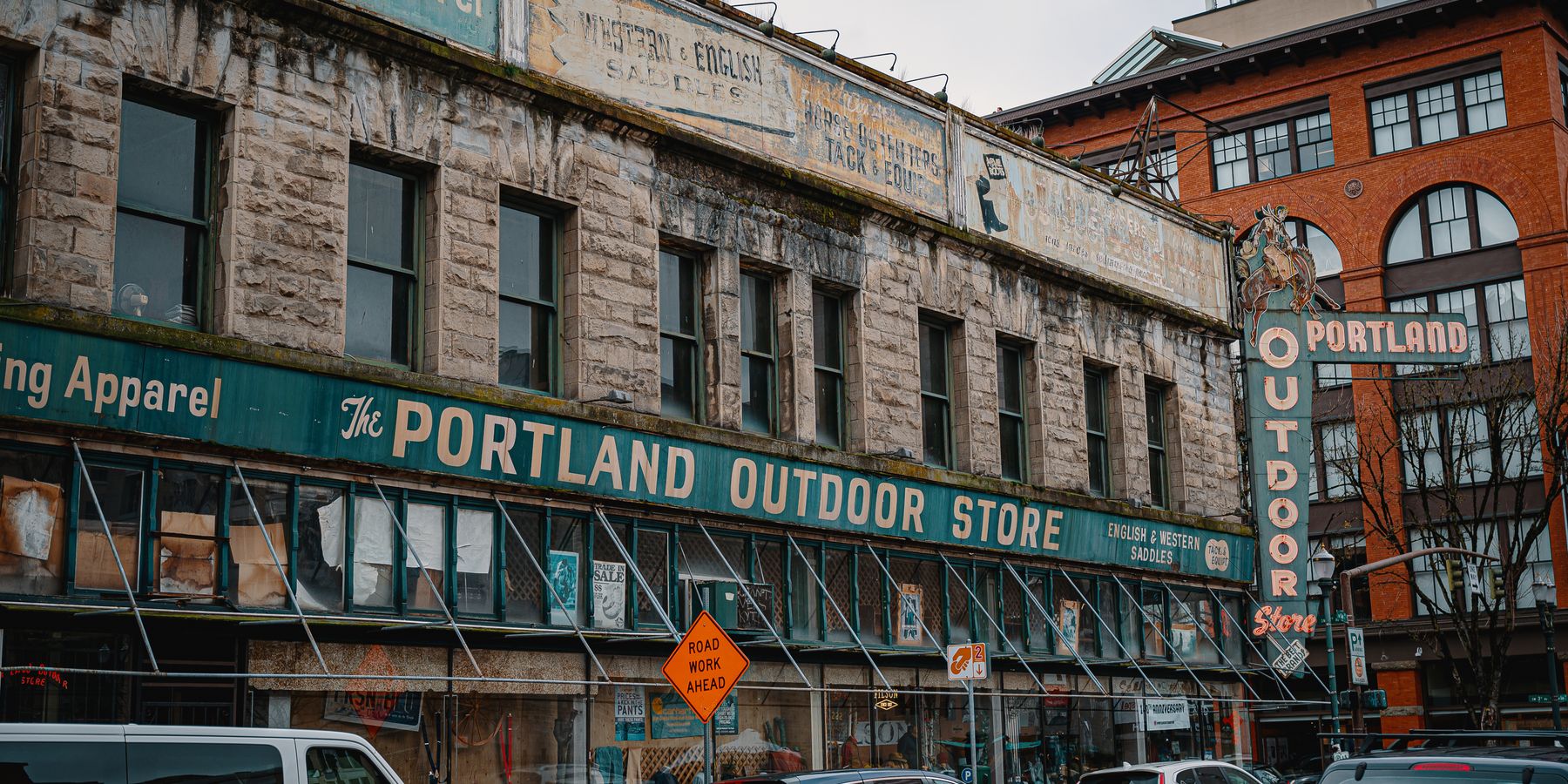 Street view of the iconic Portland Outdoor Store with vintage signage and urban scenery.