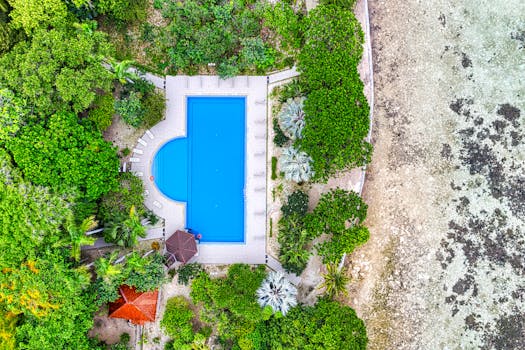 Stunning drone shot of a pool amidst lush greenery in Jakarta, Indonesia.