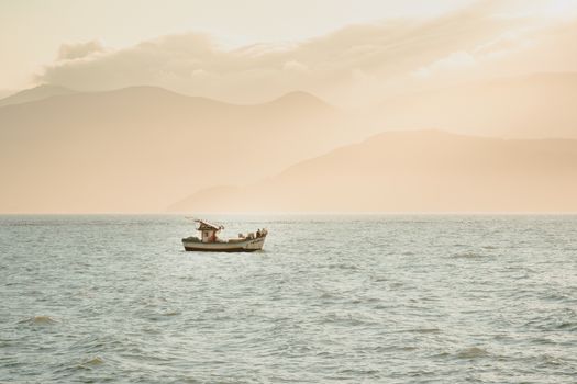 Serene fishing boat on the calm waters at sunrise in Santa Catarina, Brazil.