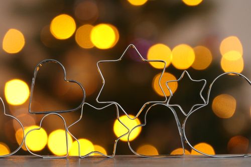 Free Heart and star cookie cutters with warm festive bokeh from Christmas lights in the background. Stock Photo