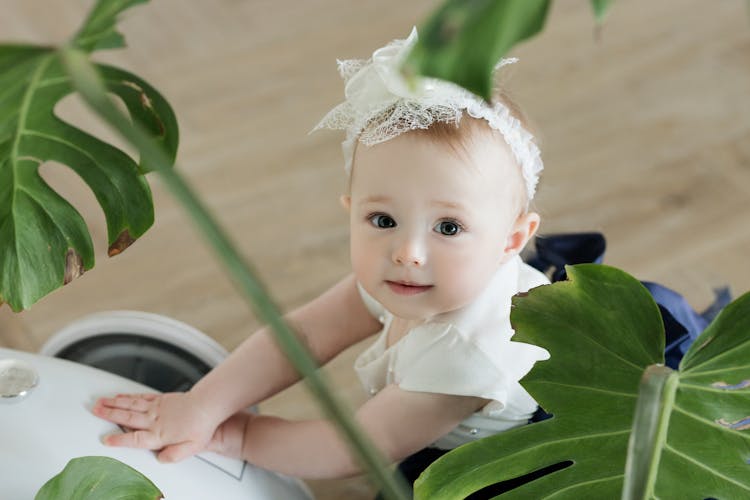 Baby In A White Headband 