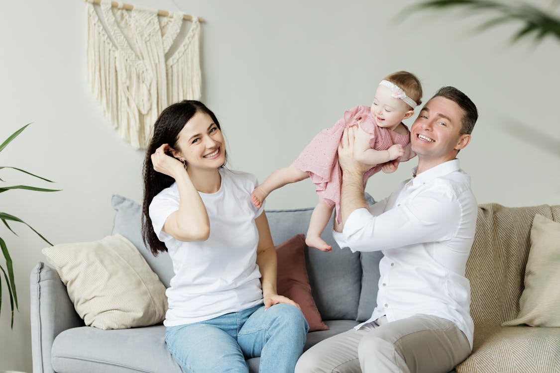 Free Photo of a Couple Sitting With a Baby  Stock Photo