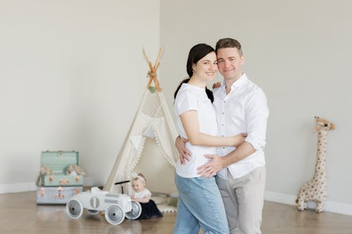 A joyful family with a toddler in a cozy room with playful decor and a teepee.