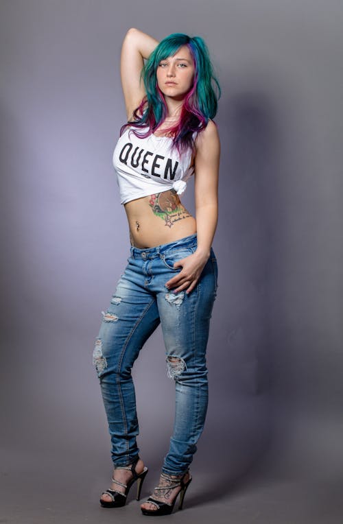 Free Woman in White Crop Top and Blue Denim Jeans Stock Photo