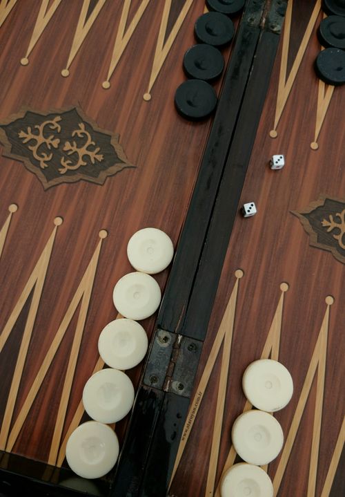 Free Elegant backgammon board with pieces and dice. Ideal for game enthusiasts. Stock Photo