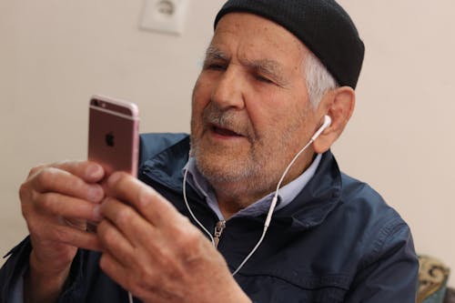 Free Man in Black Knit Cap Holding Iphone 6 Stock Photo