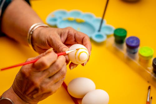 Close up of hands Coloring Easter Eggs