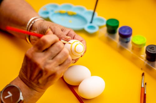 Person Painting White Egg