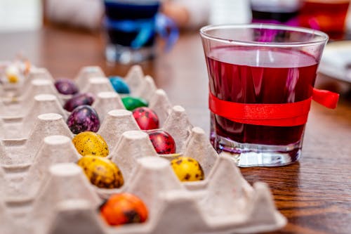 Easter Eggs in Palette Tray Beside Clear Glass With Colored Liquid