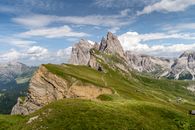 Green Grass Field And Mountain Under Blue Sky