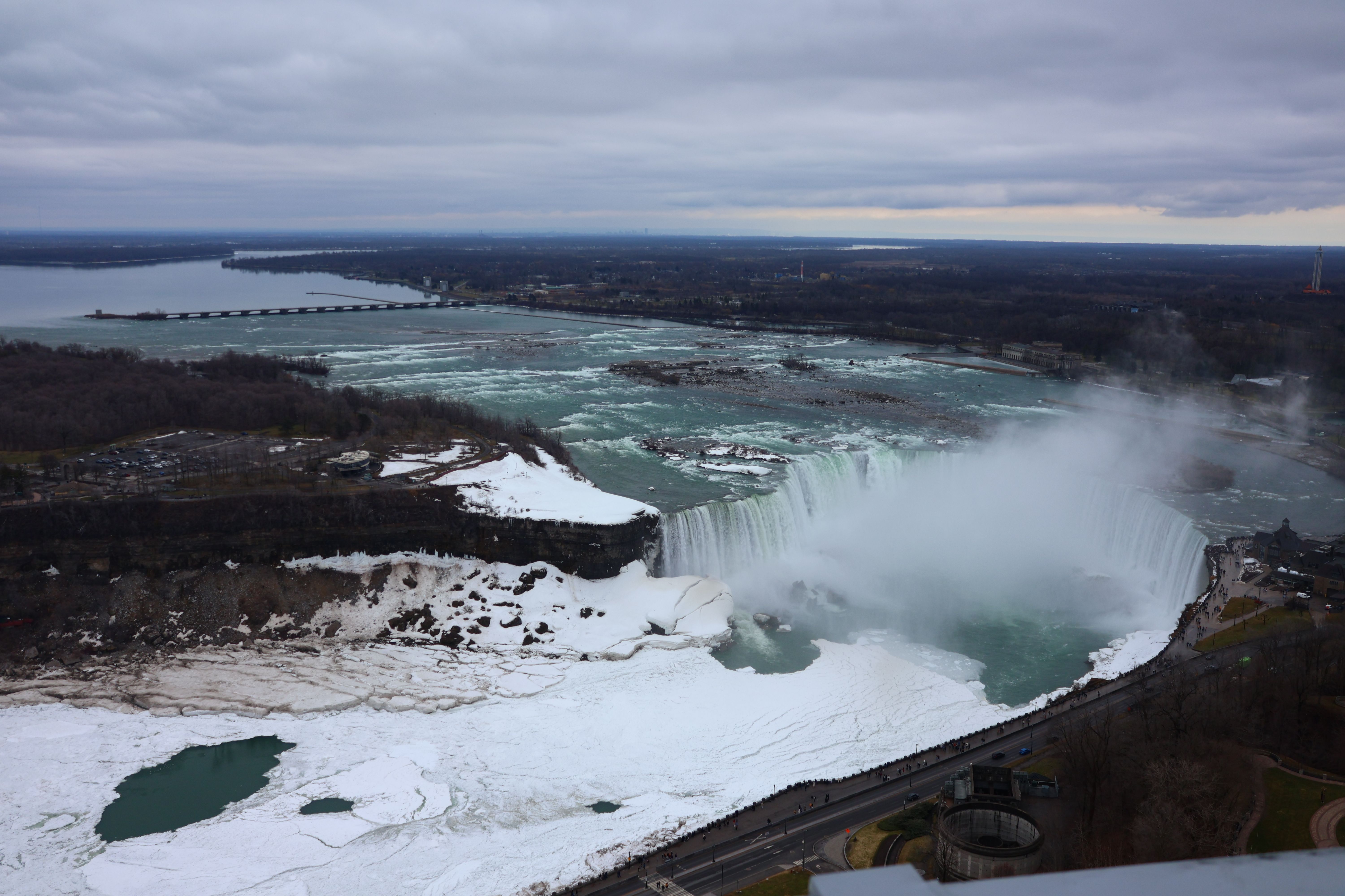 Scenic aerial view of Niagara Falls partially frozen during winter season.