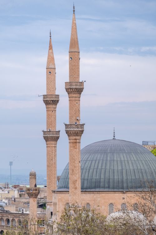Free Beautiful minarets of a mosque stand tall against a soft cloudy sky, showcasing Islamic architecture. Stock Photo