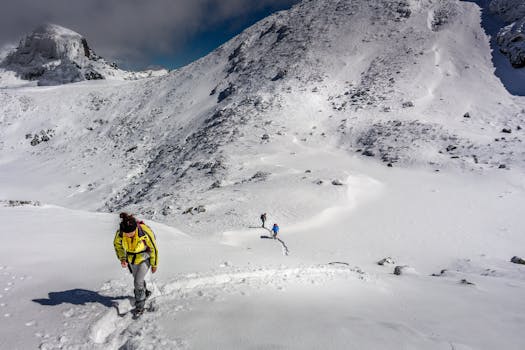 Hikers traverse a snowy mountain trail in Bulgaria’s breathtaking landscapes. by Chavdar Lungov