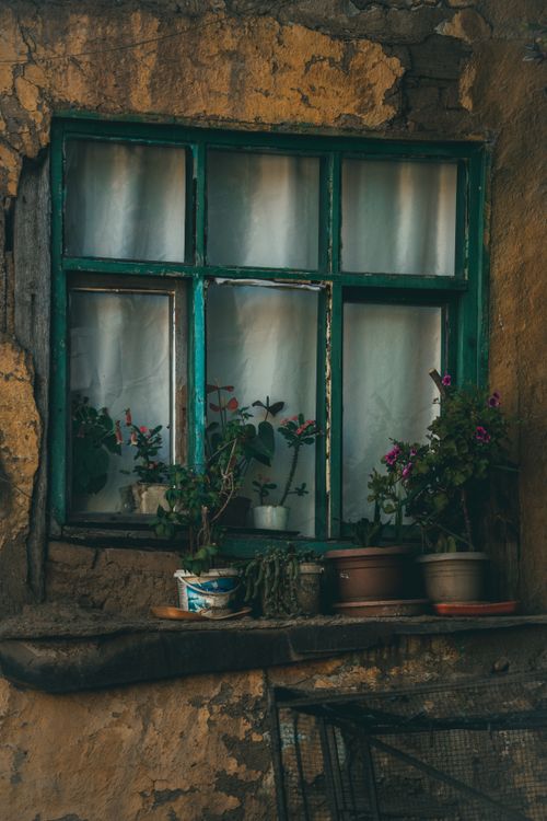 Free Charming window with potted flowers on rustic facade in Bursa, Turkey. Stock Photo