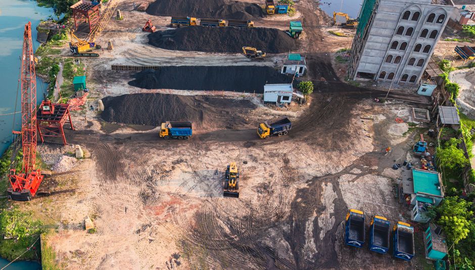 Aerial view of construction site with machinery in Dhaka, Bangladesh.
