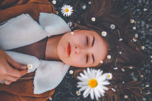 Free Woman Lying On Bed Of Flowers Stock Photo