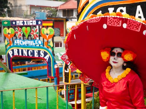 Colorful Day of the Dead scene with a Catrina character in Xochimilco, Mexico City.