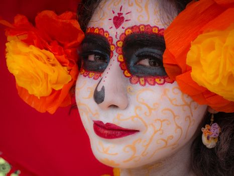 Close-up of Day of the Dead makeup with vibrant colors during a festival in Mexico City.