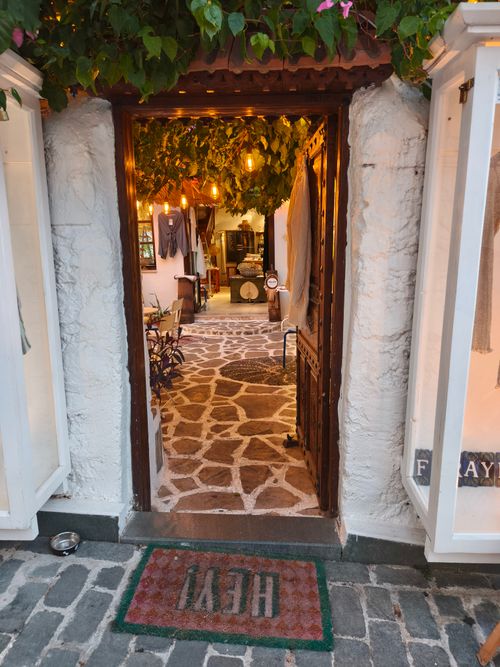 Free Inviting view into a cozy cafe with a rustic Mediterranean style and warm lighting. Stock Photo