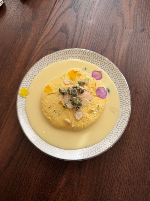 Free Delicious bowl of Indian Rasmalai garnished with nuts and petals, showcasing traditional cuisine. Stock Photo