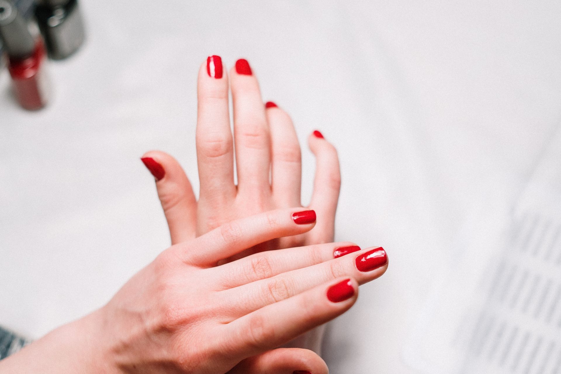 Close-up of a fresh glossy red manicure at Nail Studio in Temple Hills, Maryland