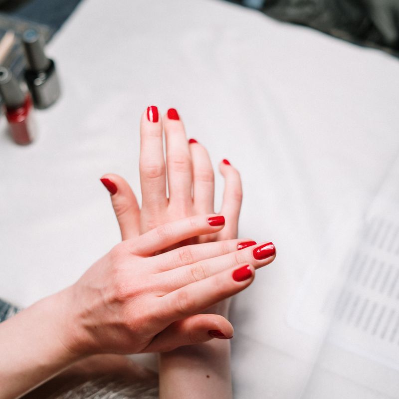 Glossy red manicure finished at Nail Studio