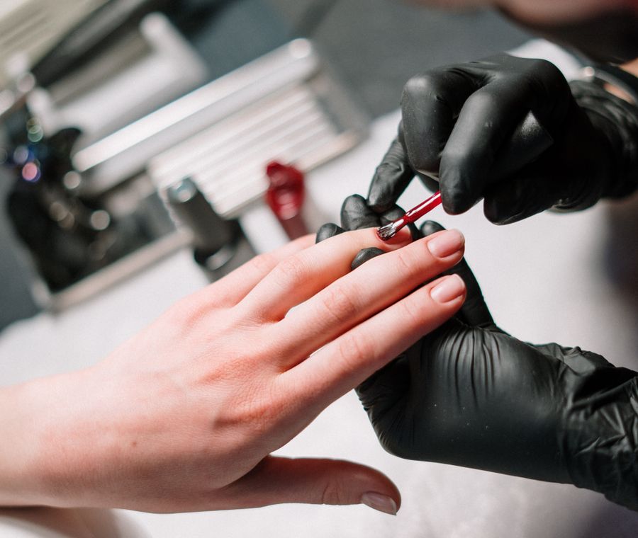 Nail artist applying a detailed custom gel design at Nail Studio