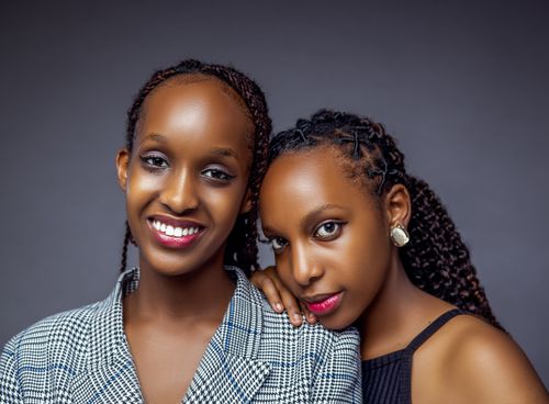 Free Vibrant portrait of two smiling women against a neutral background. Stock Photo