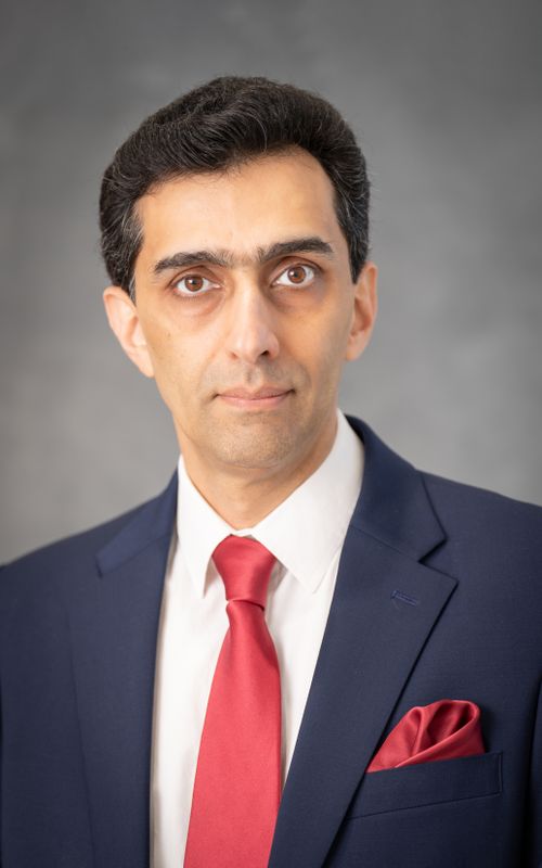 Free Formal portrait of an adult man wearing a navy suit and red tie, ideal for business themes. Stock Photo