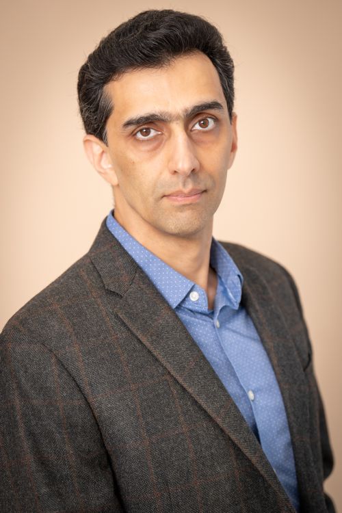 Free Formal studio portrait of a man in a suit with a neutral background for business use. Stock Photo