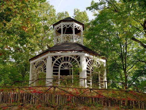 Free A picturesque wooden gazebo surrounded by greenery in Zielona Góra, offering a tranquil retreat. Stock Photo