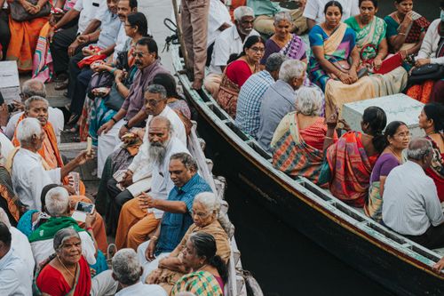 Free A vibrant group of people in traditional attire travel on a boat in Varanasi, India. Stock Photo