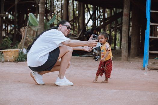 A friendly interaction in the rural setting of Kampong Phluk, Cambodia.