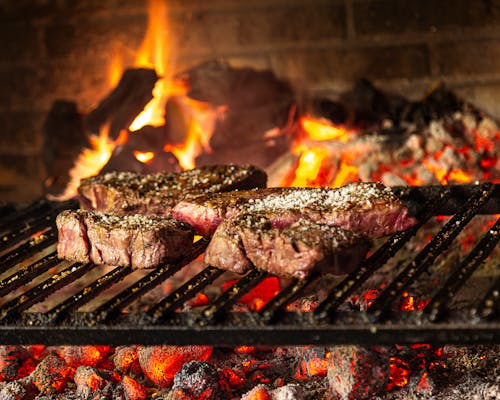 Free Grilled Meat On Charcoal Grill Stock Photo