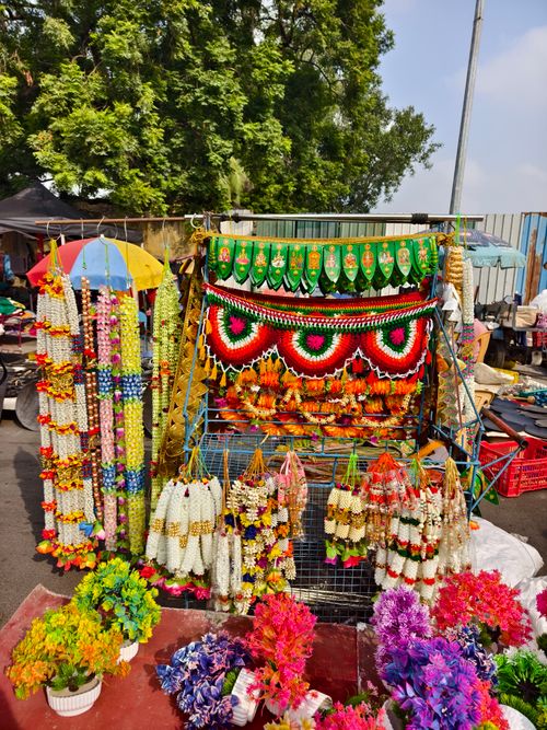 Free Colorful display of floral garlands and decorations at a street market in Chennai, India. Stock Photo