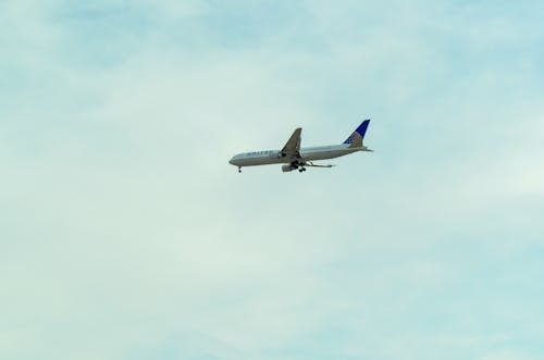 White and Blue Airplane in the Sky