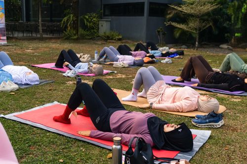 Free A diverse group of women participates in an outdoor yoga session on grass. Stock Photo
