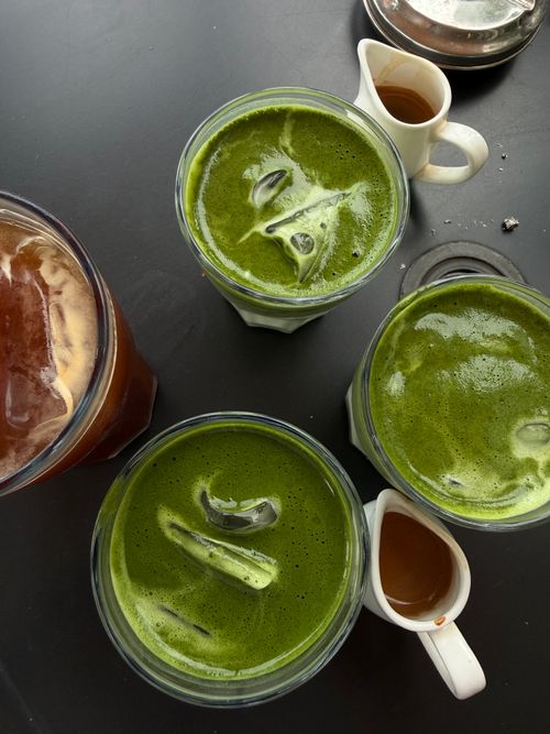 Free Top view of iced matcha and coffee drinks on a dark table, capturing a refreshing variety. Stock Photo