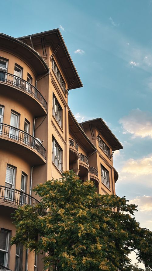 Free Classic residential building with arched balconies against a clear sky in Türkiye. Stock Photo